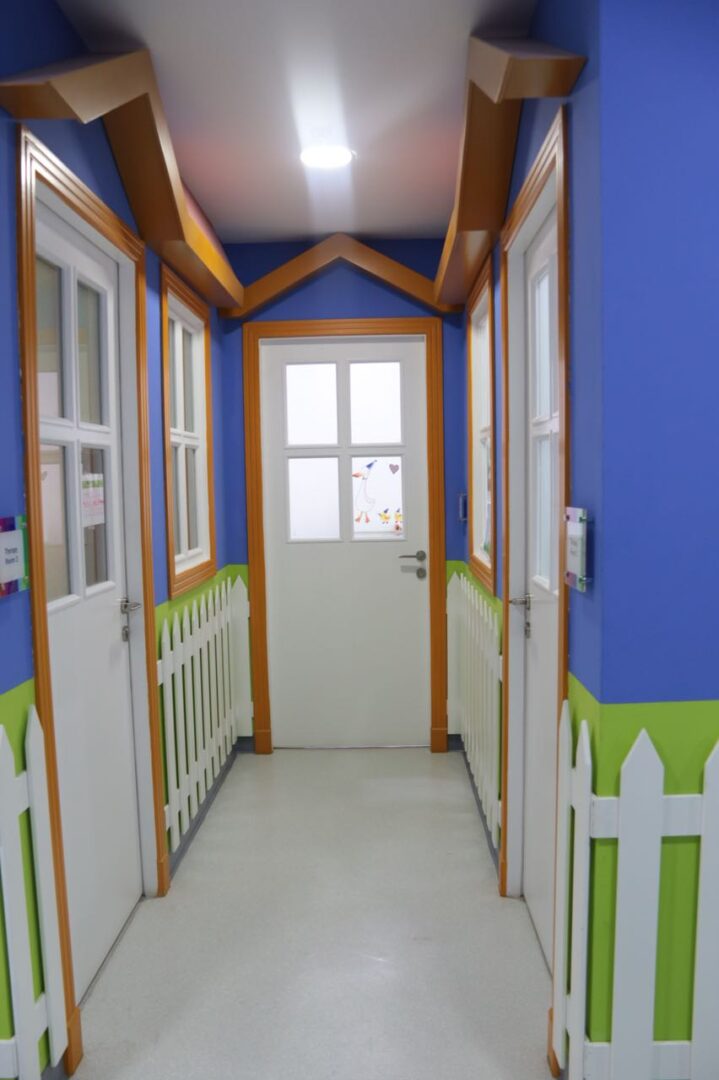 A hallway with white doors