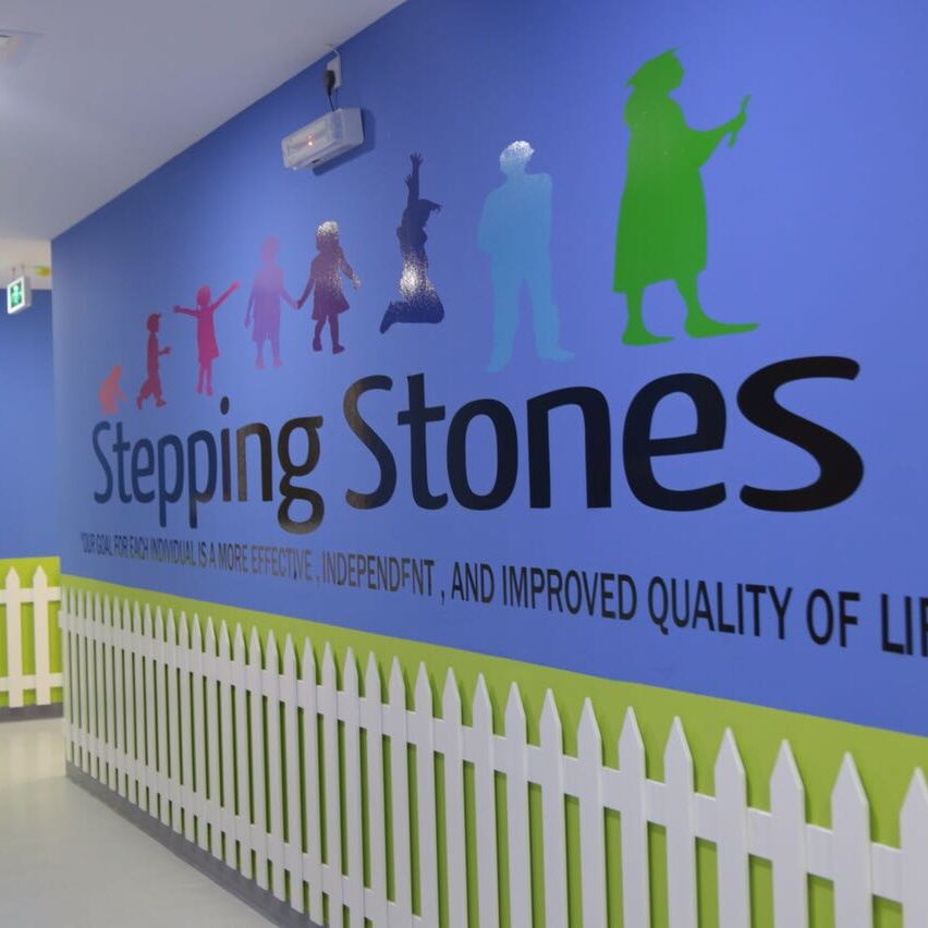Colorful wall mural with the text 'Stepping Stones' and playful figures.