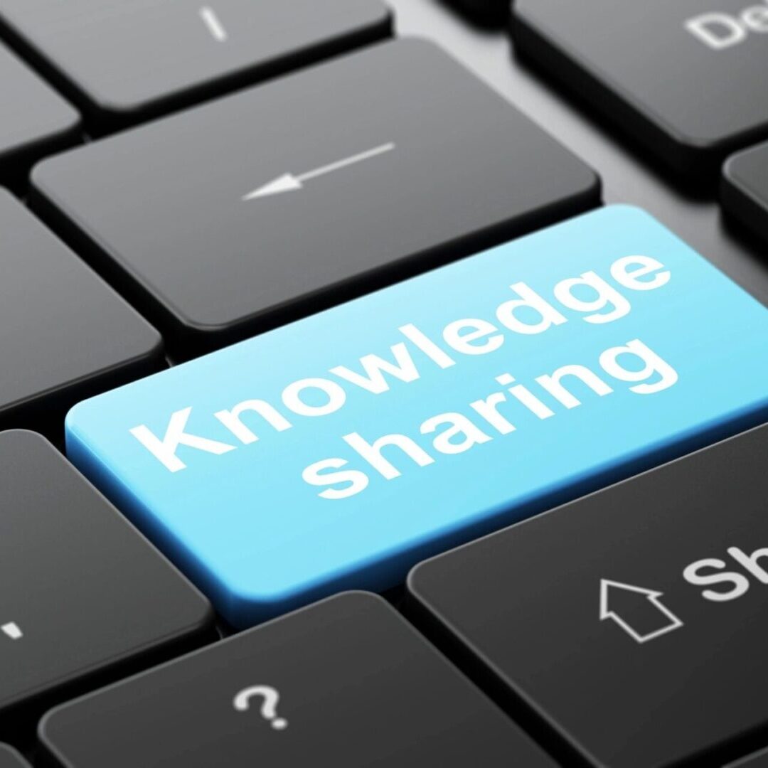 A keyboard key labeled 'Knowledge Sharing' in blue.