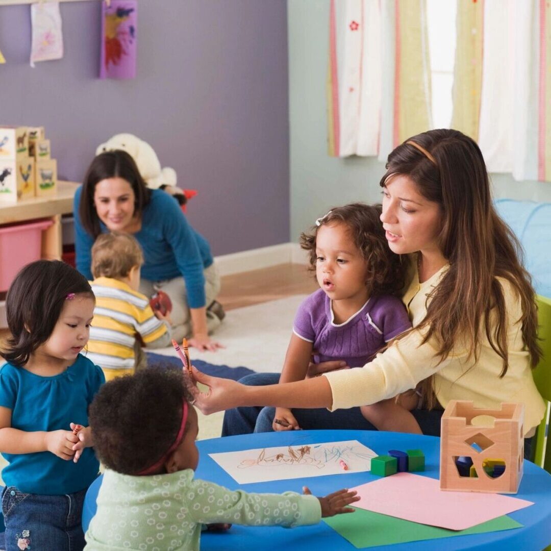 A mother and children playing a board game at a table indoors.